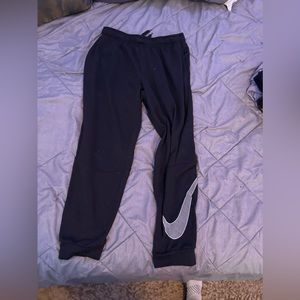 Black Nike sweatpants with swoosh on left calf, used but good condition Size L